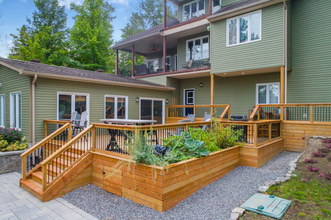 Stock photograph: a multi-level cedar deck with railings, stairs and board skirting.