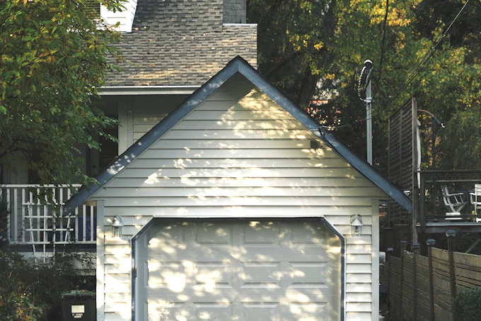 Stock photograph: a detached single-bay garage with clapboard siding and a gable roof.
