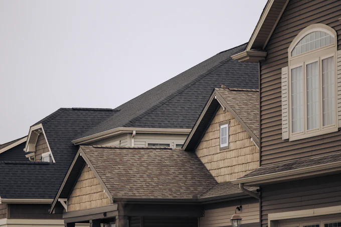 Stock photograph: asphalt shingle roof and gables on a two-storey house.